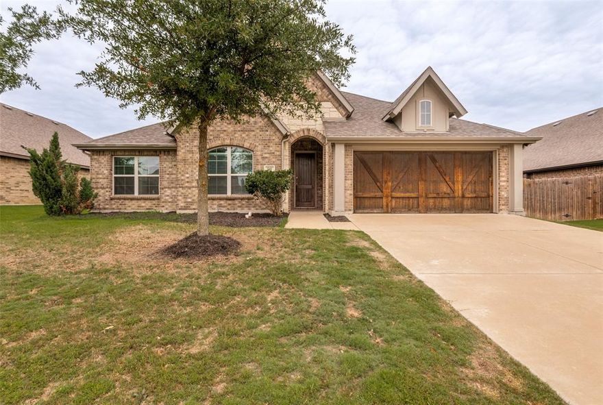 You enter into a large open floor plan and the house sits on a large corner lot. Stunning elevation, 8-foot interior doors, mudroom, stunning dining room open to the spacious kitchen and living area with decorative fireplace. The kitchen offers cabinets to ceiling, large over sized pantry, light grey glass tile back splash, large kitchen eat at kitchen island, and granite counter tops. This home offers a split bedroom concept with a custom barn door on front room. Front room could be used as an office or 4th bedroom it does have a large closet. Master suite is very spacious offering separate sink areas, one with vanity, 2 large walk-in-closets, separate shower and large soaking tub. The home sits on a large lot with an extended patio.