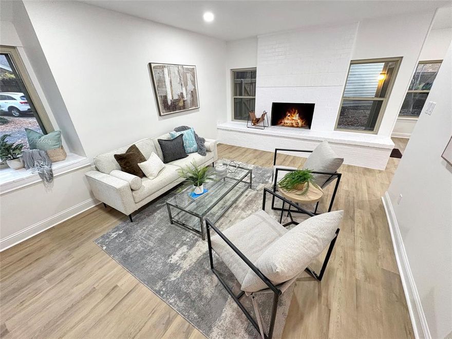 This beautifully renovated Townhouse in Town North offers modern updates and a prime location! Brand new kitchen appliances (dishwasher, electric range, microwave), new kitchen countertops and cabinets, fresh carpet, and paint make it move-in ready. The updated bathrooms feature new countertops, vanities, toilets, and tile throughout. Upstairs, two spacious bedrooms with vaulted ceilings and ensuite bathrooms await, one with a fireplace and the other with a perfect study nook. The entire home is filled with large, recently updated windows, allowing natural light to flood the space. The cozy living room includes a wood-burning fireplace. Step outside to a beautifully landscaped terrace with serene trees and concrete pavers. This community has direct access to the SoPac Trail, which leads directly into the White Rock Lake Trails. Additional updates include foundation repair, updated HVAC, and plumbing repairs. A 2-car garage, corner location, and access to the community pool complete this home. Just minutes from shopping, dining, White Rock Lake, and Lakewood Elementary!