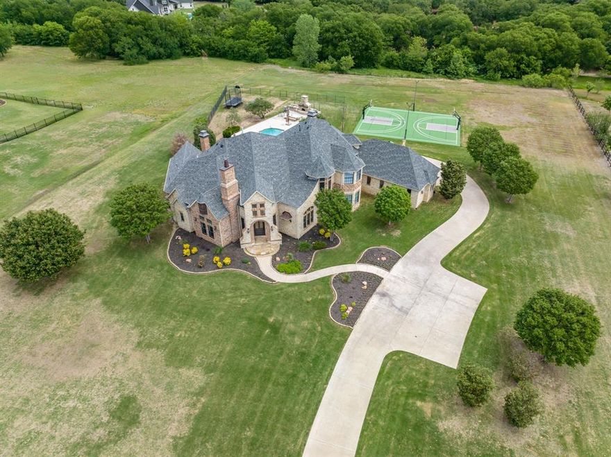 Welcome home to 850 Manor Dr. in the prestigious and coveted Argyle neighborhood of Texas! This remodeled masterpiece is undoubtedly one of the area's most sophisticated retreats. With approximately 5,000 sq. ft. of living space and 3 acres of sprawling manicured grounds, stunning pool, sports basketball court, and fully amenitized outdoor entertaining areas, there is little left to the imagination. This magnificent 5-bedroom, 5-bathroom home offers the ideal balance of luxury and comfort. The recently remodeled gourmet chef's kitchen features quartz countertops, a plethora of entertaining space, ample storage, stainless appliances, a walk-in pantry, and flows seamlessly into the wine room, living room, and dining area. The sun-filled primary suite is the perfect place to relax and unwind. A formal study, cozy fireplace, smart home system, and 3-car garage are some additional highlights. Located in the highly sought-after Argyle school district, close to shopping, dining, and highways.