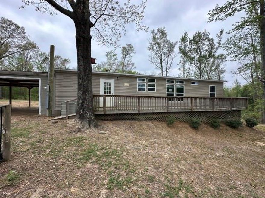 3 bedroom, 2 bath doublewide on over 16 acres with attached carport and a barn style workshop. Home has an open floor plan with island kitchen and fireplace in the living area.  Freddie Mac's First Look period for owner occupants expires 5-7-26.