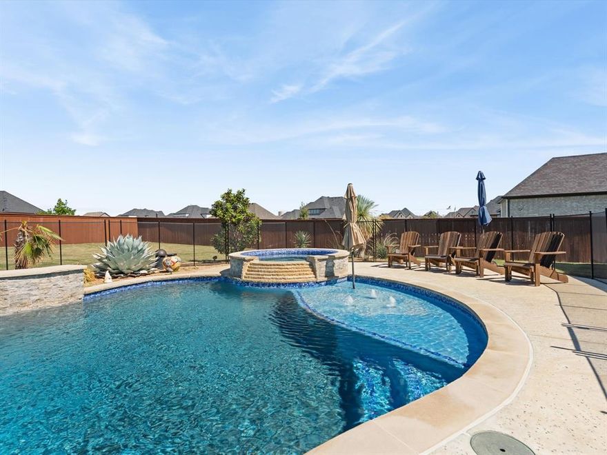 This immaculate 4-bedroom, 4.5-bath home offers luxury, comfort, and modern living on a spacious ½-acre lot in the highly sought-after Northwest ISD. Step inside to find beautiful hardwood floors flowing through the main living areas, soaring vaulted ceilings, and a thoughtfully designed open floor plan perfect for entertaining. The gourmet kitchen features sleek quartz countertops, a large center island, stainless steel appliances, and ample cabinetry—ideal for both everyday living and hosting guests. The private study provides the perfect space for working from home or quiet reading. Every bedroom includes its own bath, offering privacy and convenience for family or guests. The smart home system keeps comfort and security at your fingertips. Step outside to your own backyard retreat, complete with a sparkling pool, relaxing hot tub, and plenty of space to play or unwind. Home offers a spacious 3-car garage. With top-rated schools, modern amenities, and timeless finishes, this home truly has it all.