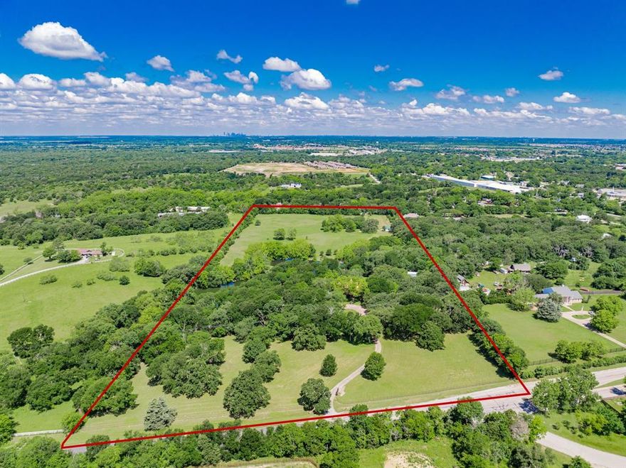 Fantastic multi-gen living opportunity—no HOA and only a short 20-minute drive to Downtown Dallas!
Remarkable 19+ Acre Estate Just 20 Minutes from Dallas
Discover a rare gem nestled just southeast of Dallas—19+ beautifully manicured acres featuring two tranquil, stocked ponds, and a canopy of majestic trees, including live oaks, elms, post oaks, and pecans. This exceptional property offers a harmonious blend of natural beauty and refined living. Fully sodded yard with water views, lush landscaping, and irrigation system sourced from ponds.
The main residence boasts 4 spacious bedrooms and 3 full baths and 2 half baths, with each bedroom enjoying direct access to a private or shared bath, including a Jack-and-Jill setup. Work from home in the private office nook in the primary suite. Tons of storage throughout, with walk-in closets in every bedroom, a spacious cedar walk-in closet upstairs, and a large walk-in attic for additional storage. Multiple living areas provide room to relax or entertain, anchored by a striking wood-burning fireplace crafted from authentic Chicago brick.
The home is crowned with a metal copper roof finished in Firestone, adding both elegance and durability. Enjoy unforgettable moments in the architecturally stunning great room, including a wet bar and half bath, complete with a private balcony overlooking the ponds and expansive yard.
For the hobbyist or car enthusiast, the estate includes additional 6-car garages including RV storage. Plus, guests will feel right at home in the 1,200 sq ft guest house, featuring its own private, gated entrance. The property also includes a 3-stall chain-link dog kennel, perfect for pet owners or hobby breeders. And with plenty of open land, bring your horses or livestock to complete your dream ranch lifestyle.
This property must be seen to truly appreciate its charm, craftsmanship, and serenity. A perfect combination of luxury, comfort, and country living—just minutes from the city.