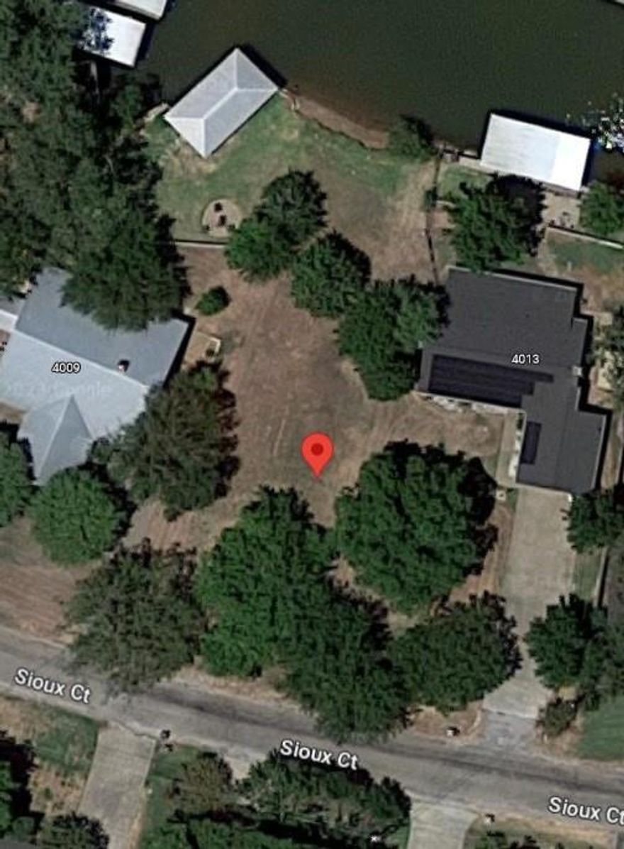 Waterfront Lot in Indian Harbor! Gated community with pool, marina, and boat ramp with canal access to Lake Granbury! We have plans drawn that could be built on this lot.