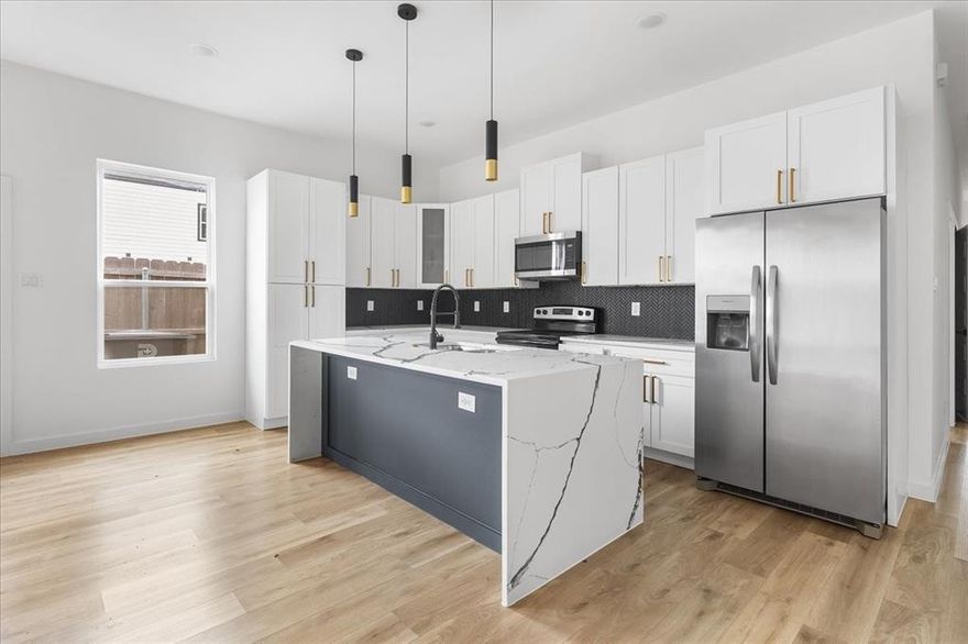 Discover a contemporary new-construction half-duplex in central Dallas - 4 beds, 2 baths. Bright, open floor plan with plenty of natural light. The chef-ready kitchen features quartz counters, gray shaker cabinets, stainless steel appliances, and a large island that flows into the living and dining space. This unit is being sold individually, the other side is already sold. Ideal for rental income or Airbnb, situated in a rapidly developing neighborhood with quick access to highways, shopping, and restaurants. Ready for immediate move-in.