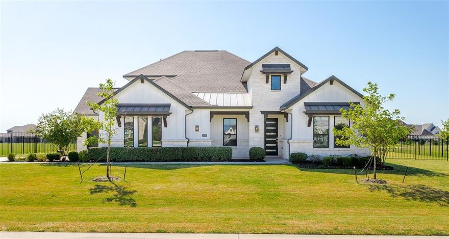 Stunning residence, Impeccably maintained & perfectly nestled on a generous 1 acre homesite in the highly sought after community of Lakeview Downs! This thoughtfully designed luxury home features 4 bedrooms, 4 beautifully appointed bathrooms along with open concept living, seamlessly connecting the main living areas offering both comfort & functionality. The spacious & inviting main living area is equipped with huge sliding glass doors with views to the expansive backyard, offering luxury living both indoors & out. At the heart of the home is a grand culinary kitchen that flows into the dedicated dining area, equipped with high end finishes, complete with beautiful quartz countertops, white cabinetry, glass-front display uppers, large center island with counter top seating, five burner gas cooktop & generous counter space, perfect for preparing meals & entertaining guests. The Primary bedroom offers a serene retreat with a spa-like bath complete with dual quartz-topped vanities, elegant free standing soaking tub, huge walk in his & her closets & direct laundry access for your convenience. A Jack & Jill bathroom connects two of the secondary bedrooms which is ideal for hosting overnight guests. The versatile upstairs bonus room promises countless hours of entertainment, perfect for movie nights or cozy gatherings. Other features include beautiful wood flooring, 8 ft doors, elevated ceilings, full gutters, sprinkler system, stone-accented exterior & sleek & contemporary curb appeal with a 3 car garage. Step outside to the fully fenced-in yard with an extended covered patio & a massive backyard with plenty of room for all of your outdoor activities, gardening aspirations or the addition of a swimming pool. It’s ample space to create your dream backyard retreat. This home is where sophistication meets comfort in every detail! With its convenient location near shopping, dining & Lake Lavon, this home combines both tranquility & convenience with luxury living!