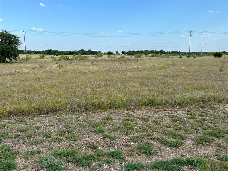 $500 Buyer’s Concession with an Acceptable Full-Price Contract by 11-30-25! OUTSIDE CITY LIMITS – This versatile lot offers endless opportunities! The front half faces FM 1713, a high-traffic area with strong visibility and is zoned commercial, while the back portion provides potential for residential use (per seller’s understanding). Whether you’re looking to build, invest, or create a live-work space, this property gives you the flexibility to bring your vision to life. Located in Whitney, a thriving and growing lake community perfectly positioned between Dallas and Waco, you’ll enjoy both convenience and small-town charm. Don’t miss this chance to secure a property with prime exposure and multiple possibilities!