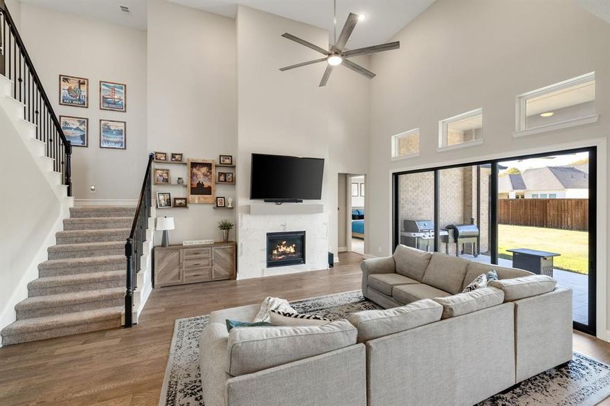 Completed in 2023, this beautifully updated Toll Brothers home offers 4 bedrooms, 3.5 baths, and a 3-car garage, blending modern comfort with timeless style on a serene .3-acre interior cul-de-sac lot. Upgraded lighting and fresh interior paint set a warm, welcoming tone throughout, while new wood flooring on the first level and new oven, microwave, dishwasher, and EV charging station add thoughtful convenience. At the front of the home, a private office provides a quiet place to work or study, and a spacious secondary bedroom with walk-in closet and ensuite bath creates an ideal setup for guests or multigenerational living. Tucked at the back, the private Owner’s Retreat features a tray ceiling along with a spa-inspired bath that includes dual vanities, a soaking tub, oversized shower, and generous walk-in closet. The bright, open living area is the heart of the home, boasting a wall of windows overlooking the expansive backyard, a cozy fireplace, and seamless flow into the kitchen and dining space. The well-appointed kitchen delights with a gas cooktop, vented exhaust fan, double ovens, Black Python granite counters, under-cabinet lighting, a large island, and a new sink with touch faucet. Upstairs, two additional bedrooms—each with a walk-in closet—are joined by a media room, game room, and a full bath, offering wonderful flexibility for entertainment, creativity, or quiet retreat. Outside, an oversized tiled patio with a motorized screen invites year-round relaxation and outdoor dining, overlooking a pool-sized yard with lush grass and a storage shed. Just down the street, the community’s lazy river and playground await, and residents also enjoy a resort-style pool, clubhouse, over four miles of trails, parks, and fields of seasonal wildflowers—plus the convenience of an on-site elementary school. A home like this pairs everyday luxury with an unbeatable lifestyle, making it a place you’ll love coming home to.