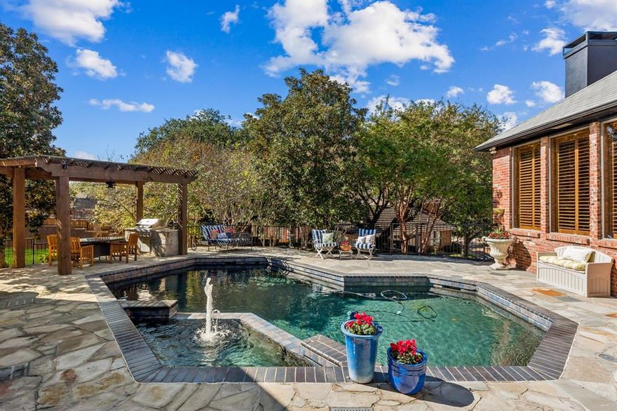 Experience resort-style living in this stunning custom home owned by Herschel Walker, perfectly positioned at the end of a quiet cul-de-sac. Set on an oversized, beautifully landscaped lot in the prestigious guard-gated Cottonwood Valley community, this home is just a golf cart ride from the Ritz-Carlton and Nelson Sports Club. Designed for comfort, privacy, and year-round entertaining, it offers a pool and spa, outdoor kitchen under a cedar pergola, multiple lounging areas, and a large fenced yard ideal for pets or play. Enjoy two downstairs bedrooms plus an upstairs suite that can serve as a second primary. A stone walkway leads to the timeless brick exterior. Inside, craftsmanship shines through upgraded finishes including pewter knobs, herringbone floors, warm textures, and elegant architectural details. The dramatic foyer opens to a grand living room filled with natural light from expansive windows overlooking the backyard oasis. Nearby, the executive study features wood paneling, beamed ceilings, built-ins, and front views—an ideal work-from-home retreat. The spacious primary suite offers room for seating, a spa-inspired bath with dual vanities, soaking tub, walk-in shower, and dual closets. A second primary suite upstairs adds flexibility for multi-generational living or long-term guests, complete with walk-in closet and attached living area. The downstairs guest room includes an ensuite bath, and an additional upstairs bedroom with safari-themed murals is perfect for a child or creative space. Step outside to your private resort with a lagoon-style pool, raised spa, fountain, and stone decking. The pergola includes a built-in grill, dining area, ceiling fan, and shaded lounging. Mature trees add privacy, and the extended lawn expands outdoor versatility. An oversized three-car garage with storage and a long driveway provide ample parking. Minutes from airports, major venues, & premier dining, this home blends classic elegance with exceptional outdoor living.