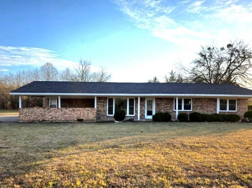 Set on just over two acres in the quiet countryside of Red River County, this charming 1971 ranch-style home offers a rare blend of simplicity, character, and space to breathe. Thoughtfully maintained over the years, this 2-bedroom, 2-bath home reflects a time when homes were built with intention, durability, and warmth.

Inside, you’ll find inviting original details that give the home its soul—classic built-ins, vintage flooring, and a cozy fireplace that anchors the living space and instantly makes it feel like home. These timeless features pair beautifully with the home’s well-cared-for condition, creating an atmosphere that feels both nostalgic and comfortable.

Recent updates provide peace of mind, including a newer roof and an updated septic system, while city water adds everyday convenience. The brick exterior speaks to the home’s lasting quality, and an additional storage shed on the property offers extra space for tools, hobbies, or outdoor equipment.

The land itself is a true highlight—mostly open with beautiful, mature shade trees that invite quiet mornings, afternoon breezes, and evenings spent outdoors. A portion of the acreage is fenced, creating a defined backyard space while still allowing room to expand, garden, or enjoy the open land beyond.

Located just off the main road, this property offers easy access without sacrificing the tranquility of rural living. It’s a place where life feels a little slower, evenings feel a little quieter, and home feels exactly how it should.

If you’ve been searching for a well-maintained home with character, land, and timeless charm, this Red River County gem is one you’ll want to experience in person.