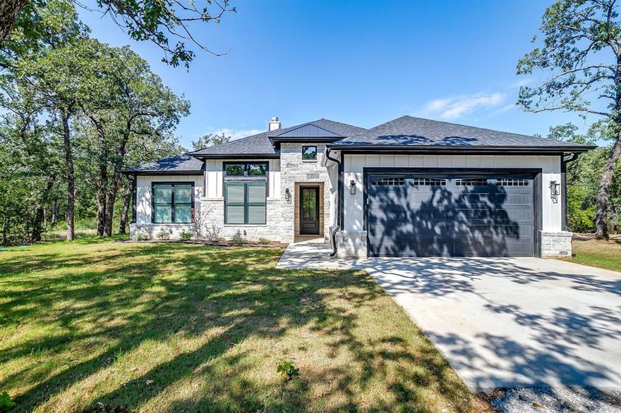 Brand new, beautifully designed, and built for life on 2 acres—this is the Texas dream, ready to come true. Nestled in the quiet Oak Haven community just outside Bridgeport, this 4-bedroom, 2-bath home blends modern style with wide-open space. With 2,053 sq ft of thoughtfully crafted living space, every detail is designed for comfort and function. The open-concept layout features, a spacious living area with a wood-burning fireplace, and a stunning kitchen with granite counters, stainless steel appliances, and a large island perfect for gathering. The private primary suite is your retreat—with double sinks, a walk-in shower, and a generous closet. Enjoy peaceful views from the covered front porch, with plenty of room to add a shop, garden, or pool. A 2-car garage, well and septic, and no HOA give you the freedom you’ve been looking for. Whether you're looking for room to grow, relax, or entertain—this home checks every box