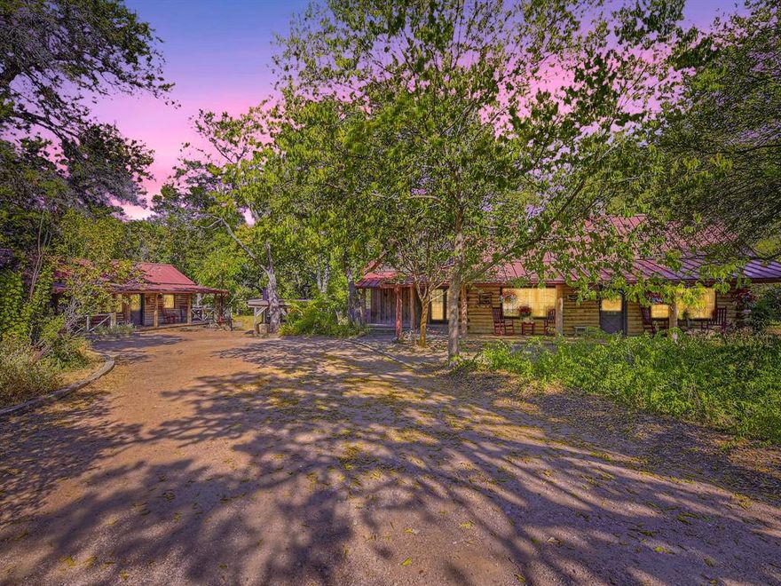 Rare Opportunity * Family Retreat * 120+ ft. of Cypress Creek * .5 mile to Wimberley Square * Across from Blue Hole Preserve * Income Generating * Nestled amidst the captivating beauty of the Hill Country, Abundance Retreat offers an idyllic escape that blends rustic charm with modern comfort. The large main lodge, Sundance, boasts 3 bedrooms & 2.5 baths, ensuring ample space for relaxation & privacy. An expansive great room accented by a vaulted 28-foot ceiling with cedar beams enhances the elegant, enjoyable atmosphere. The guest house, Moondance, is a combined living and sleeping area for a cozy night's rest. An alluring private bath and dry sauna beckon you to relax and unwind after a day spent in nature. Property is income-producing, zoned commercial & includes a transferrable CUP STR license. Visitors will love the walking proximity to Downtown Wimberley’s idyllic shops, antique stores & eateries. Buyers to confirm schools-Blue Hole, Danforth and Wimberley.