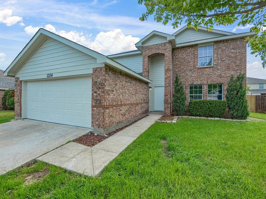 Move-in ready two-story in Shale Creek with 2,560 square feet, four bedrooms, two and a half baths, and a layout that actually works for how people live. Northwest ISD.
The kitchen features white shaker cabinets, black granite countertops, subway tile backsplash, stainless steel appliances, and a matte black farmhouse faucet over a double basin sink. It opens to the main living area without losing definition between the spaces. Dark hardwood-style flooring runs through the downstairs living areas, and the wood-burning fireplace with white surround gives the living room a natural focal point.
The main floor also includes two dining areas, a dedicated utility room with extra freezer space, and a half bath off the main living area. The downstairs primary suite has a walk-in closet and private full bath, with good separation from the rest of the home.

Upstairs, three secondary bedrooms each have solid closet space and natural light. The large game room runs just over 20 feet wide and works equally well as a second living area, media room, playroom, or home office. Fresh carpet throughout the second floor.

Additional features include a 2-car garage, rain gutters, and a sprinkler system. The neighborhood has sidewalks and a community playground.

This home pictures well but shows even better, you won't be disappointed!