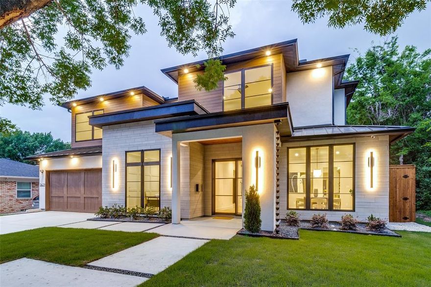 Experience the pinnacle of modern luxury by HB Projects, located in the highly sought-after Royal Hills enclave of Dallas. Spanning 4,609 sq.ft. on a 0.23-acre lot, these 5 bedrooms, 5 bathrooms estate is a masterclass in contemporary design, blending industrial strength with organic warmth. Built with precision on a slab foundation with 2x6 framing, this home is engineered for longevity. The exterior is a sophisticated blend of smooth stucco, natural limestone, and composite materials, highlighted by a grand iron and glass entry door and a custom cedar garage door. Beyond the aesthetics, the home is fully encapsulated in foam insulation, ensuring peak energy efficiency and a whisper-quiet interior. Step onto stunning 5inch, Grade A, white solid oak hardwood floors that flow through an open-concept layout defined by soaring 10 ft ceilings. The heart of the home is the breathtaking 20.5 ft grand family room, anchored by a sleek gas fireplace and illuminated by a collection of designer modern chandeliers. The kitchen is a chef’s dream, with a massive 3cm premium quartz island and matching countertops, KitchenAid 48-inch built-in refrigerator and a 24-inch wine refrigerator boasting a 52-bottle capacity. A massive, oversized pantry meets all your organizational needs.
The huge, covered veranda has a fully equipped summer kitchen with a built-in BBQ. 8 ft cedar privacy fence, an integrated alarm system, and 6 perimeter cameras provide 360-degree peace of mind.
The primary suite serves as a sanctuary of relaxation, boasting a huge master closet and a spa-inspired bath featuring a stunning freestanding vessel tub. Modern convenience is woven into the home’s DNA with Navien tankless water heaters equipped with a hot water circulation system for instant comfort. A dedicated second-floor bar is perfect for hosting guests or late-night refreshments.