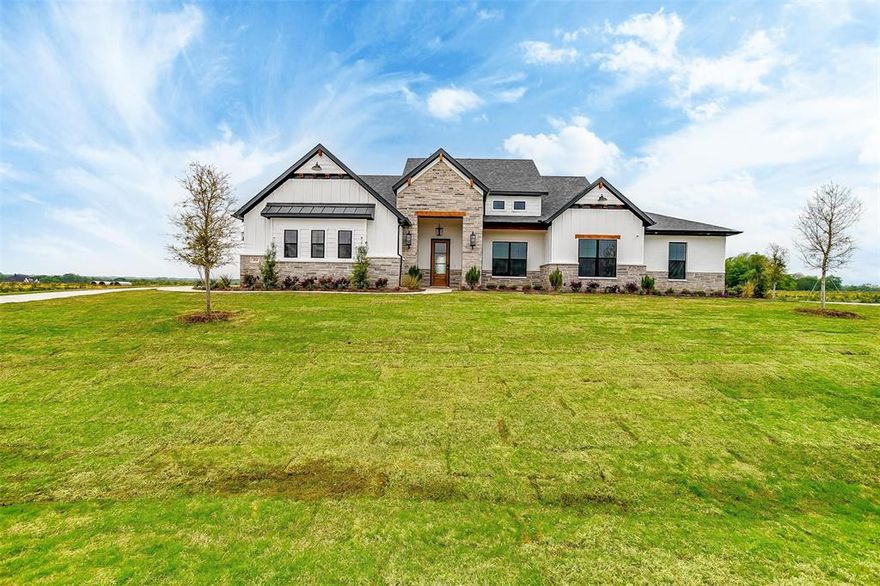 20k YOUR WAY INCENIVE! Model Home Perfection in Tuscan Estates! Welcome to this stunning completed 1-story model home on a premium corner lot in the highly sought-after Tuscan Estates. This thoughtfully designed 4-bedroom, 3-bath residence with a 3-car garage, private study, and game room showcases exceptional craftsmanship and upscale finishes throughout. The heart of the home is the show-stopping gourmet kitchen featuring custom cabinetry extended to the ceiling, a striking custom wood hood with floating shelves, double ovens, gas cooktop, and a dramatic waterfall-edge quartz island — all seamlessly opening to the family room with soaring 20-foot vaulted ceilings, stained wood beams, and a breathtaking 42inch linear gas fireplace with custom stone and tile surround reaching to the ceiling, flanked by floating built-ins. Designed for both luxury and efficiency, this home offers quartz countertops throughout, rich wood flooring in all main living areas, tray ceilings in the study, nook, game room, and primary suite, custom wall trim accents, surround sound, spray-foam insulation, insulated garage doors, two AC units, and a buried 500-gallon propane system with tankless water heater. The exterior impresses with custom painted brick and stone accents, while the expansive covered patio mirrors the home’s 20-foot vaulted ceilings — perfect for entertaining. Every detail has been curated to reflect elevated design, comfort, and performance, making this model home masterpiece in Tuscan Estates a truly rare opportunity.