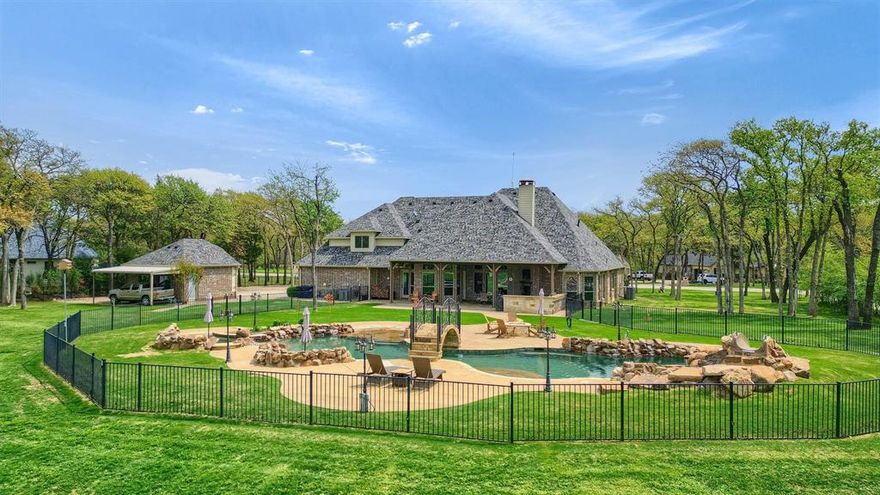 Improved Price! Luxury Living in Timberlake Trails – Resort-Style Retreat Surrounded by Nature
BRING YOUR HORSES – Community Covered Riding Arena Discover this immaculate, custom-built 4-bedroom, 3.5-bath home in the prestigious gated equestrian community of Timberlake Trails. Nestled on a heavily wooded lot with wildlife exemption, this residence perfectly blends refined luxury with peaceful, nature-inspired living—featuring over $400,000 in upgrades since 2019. Inside, you’ll find hand-scraped hardwood floors, exposed beams and trusses, & a gourmet kitchen with granite countertops, new commercial-grade appliances, and an oversized island. The kitchen opens seamlessly into the inviting living area, anchored by a stunning stone fireplace—ideal for entertaining or quiet evenings at home.
The primary suite & two spacious secondary bedrooms are on the main level, along with a private office off the entry. Upstairs, a versatile bonus room with full bath offers endless possibilities as a media room, guest suite, or even a second primary bedroom. Step outside to your private resort-style oasis: 60,000-gallon custom pool with walk-in entry, waterfalls, bridge, bubblers, & lush landscaping Fully equipped outdoor kitchen with grill, fireplace, and electric sun screens. Surrounded by mature trees for privacy and tranquility
Key Features & Upgrades (Since 2019):
Whole-house 48KW Generac generator
Climate-controlled flex building (gym, studio, or office)
New roof (house & building)
Pool enhancements: pumps, slide, landscaping, sprinkler system
Outdoor kitchen renovation with new countertops & grill
Remodeled primary bath
New appliances, HVAC systems, instant hot water
Fireplaces converted to wood-burning
Wildlife Tax Exemption for reduced property taxes
Located in the heart of Texas’ Horse Country near Lake Ray Roberts, Timberlake Trails offers direct access to a community-covered riding arena and miles of scenic beauty. This is more than a home—it’s a lifestyle.