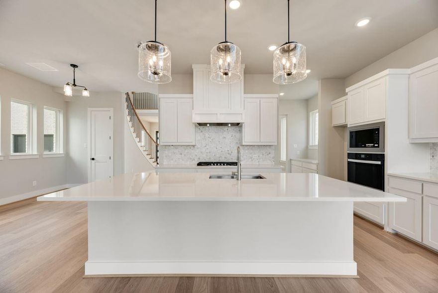 Welcome to this exceptional newly completed Grand Home in Grand Estates of Anna, offering the advantage of No MUD & No PID. Move-in ready and thoughtfully designed, this stunning home is nestled in a peaceful community while remaining conveniently close to everyday city amenities.
Featuring five generously sized bedrooms, a porte-cochère driveway, and a three-car garage, the home provides expansive living spaces ideal for both daily comfort and entertaining. The elegant light brick and stone exterior is complemented by striking double front doors, leading into a dramatic foyer highlighted by a curved full oak staircase that sets an immediate tone of sophistication.
Designed with versatility in mind, the home offers a spacious family room with soaring vaulted ceilings and a sleek linear fireplace with stone surround, a downstairs guest suite or private home office, an oversized upstairs game room, and an impressive media room complete with a snack bar—perfect for gatherings or family movie nights.
The open-concept gourmet kitchen is a chef’s showpiece, featuring an expansive island with pendant lighting, slab countertops, Shaker-style cabinetry, stainless steel appliances, a five-burner gas cooktop with custom wood vent hood, pots-and-pans drawers, a large single-bowl sink, built-in trash drawer, and a designer tile backsplash. A butler’s pantry off the formal dining area adds both elegance and functionality.
The luxurious primary suite offers a serene retreat with dual vanities, ceiling-height mirrors, and a spacious walk-in shower. Throughout the home, custom details include eight-foot interior doors with modern lever hardware, matte black fixtures, durable wood flooring, and tall six-inch baseboards, all contributing to a refined, contemporary aesthetic.
Outdoor living is equally inviting with a large covered rear patio, ideal for relaxing or grilling. Energy Star certification ensures long-term efficiency and comfort