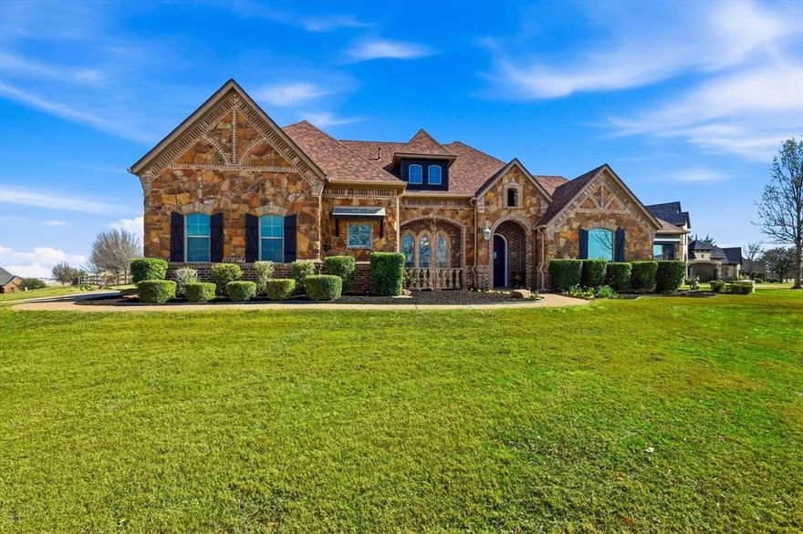 Situated on a sprawling 1-acre corner lot in the Vista Ranch community and zoned to sought-after Northwest ISD, this exceptional 3-bedroom, 3.5-bath home offers luxury living. From the moment you enter, you’ll notice the abundance of natural light, stunning interior stonework, and beautiful hand-scraped hardwood floors that flow through the inviting living spaces. The gourmet kitchen is designed for gathering, featuring granite counters, stainless steel appliances, a large island, and abundant cabinetry - all overlooking the spacious living area ideal for entertaining. The primary suite serves as a serene retreat with a spa-inspired ensuite bath offering dual vanities, a soaking tub, separate walk-in shower, and a generous walk-in closet. One of the secondary bedrooms has a private full bath and can be used as a mother-in-law suite. The upstairs game room can be converted into a 4th bedroom and offers privacy for guests or multigenerational living! The laundry room has a second water line. Step outside to your personal outdoor oasis, complete with a resort-style backyard featuring a sparkling pool, covered patio, outdoor kitchen, and pergola, creating the perfect setting for entertaining or relaxing year-round. The expansive lot, open-concept neighborhood feel, and secondary garage add both functionality and room to spread out. An automatic sprinkler system supplied by a private well means no water bills, keeping the lush landscape beautiful year-round. Recent updates include new paint and baseboards, upgraded tile flooring, 8 replaced windows, new garage doors, re-primed pergola, upgraded pool control box, new outdoor ceiling fan, and major well improvements including a new deeper well, casing, and pump - providing peace of mind for years to come. Residents enjoy community parks, walking trails, and convenient access to shopping, dining, and entertainment while still savoring the space and tranquility of country-style living.