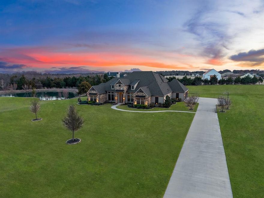 40K credit to buyer! This rare 6+ acre property in Celina with NO HOA, agricultural exemption with a low tax rate supported by an established beekeeping farm, private pond, and saltwater pool offers breathtaking sunset views and the freedom of country living in one of North Texas’ fastest-growing areas. Located in the sought-after Celina ISD, it offers peaceful country living while remaining conveniently close to the area’s growing amenities and conveniences. Built by Schramme Custom Homes, this 1.5-story home features the majority of its square footage on the main level, with only a spacious game room upstairs. Inside, the home features architectural details including brick accent arches and custom built-ins, along with a stunning stone fireplace accented with exposed wood beams. The gourmet kitchen showcases Taj Mahal countertops and backsplash, underlit cabinetry, spot-free gold faucets, a granite sink, and reverse osmosis drinking water. The entire home, including the cabinetry, has been freshly painted, and new hardwood floors flow throughout the first floor. The primary suite offers a spa-inspired bathroom with a soaking tub, separate shower, and dual vanities, while each bedroom connects to a bathroom, providing comfort and privacy. A flexible bonus room can serve as a playroom or home gym and a private study with built-ins provides an ideal work-from-home space. Upstairs, the game room features brand-new carpet and a wet bar, perfect for entertaining. Step outside to enjoy the extended covered patio with a built-in grill overlooking the saltwater pool and private stocked pond, creating the perfect setting for relaxing evenings or hosting gatherings. A convenient bathroom with patio access adds ease for poolside entertaining. Additional amenities include 50-amp RV hookups, upgraded electrical and AV systems, landscaping enhancements, and 3 refrigerators that convey. This property delivers the rare opportunity to enjoy acreage living with space and privacy.
