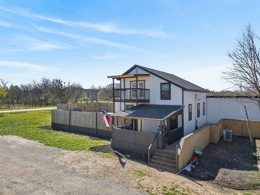 Welcome to your country retreat in the heart of Oran, TX! Built in 2023 and situated on just over 0.8 acres, this spacious 2,672 sq ft two-story home offers the perfect blend of modern comfort and small-town charm within Graford ISD. Step inside to an open-concept living area featuring soaring vaulted ceilings, warm wood accents, Luxury Vinyl Plank flooring, and abundant natural light. Beautifully updated kitchen, complete with white cabinetry, ample counter space, and a functional island—ideal for gathering with family and friends.
Featuring 3 bedrooms and 2 bathrooms downstairs and an office, one bedroom upstairs, this home offers flexible space for growing families or lots of guests. The upstairs retreat includes a private balcony—perfect for enjoying peaceful country views and Texas sunsets.
Outdoors is where this property truly shines. The custom-built entertaining area features a sunken fire pit, outdoor kitchen space, and expansive wood decking—all enclosed for privacy and designed for hosting unforgettable evenings. Whether you're grilling, relaxing by the fire, or enjoying wide-open skies, this space delivers. Additional highlights include—brand new water well; fully fenced yard, covered front porch wired for tv; plenty of room for parking or future improvements, and new septic. Located in the quiet community of Oran, just minutes from Graford and Possum Kingdom Lake, this property offers the best of rural living with convenient access to recreation and amenities. If you're looking for space, style, and a place to truly enjoy the outdoors—this one is worth a look!