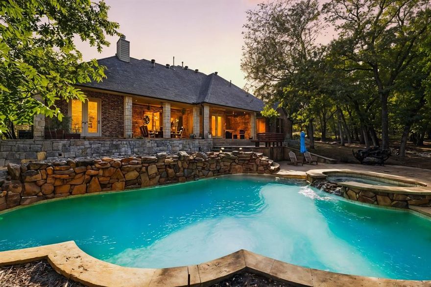 A RARE offering in the prestigious gated community of Boling Ranch. 918 Boling Ranch Road is an elegant private estate nestled on over 2 acres of manicured, park-like serenity. Spanning 3,391 sq ft, this refined residence showcases 6 beautifully appointed bedrooms & 4 baths, designed for both grand entertaining and relaxed everyday living. At the heart of the home is a chef’s kitchen of exceptional caliber, boasting high-end appliances, double ovens with warmer, an expansive pantry, and a sophisticated bar. Sun-lit living and dining spaces open to captivating views from every window, where nature’s beauty becomes part of the interior décor.The upper level reveals a second living retreat, a perfect game room or media lounge. An additional 400+sq ft of finishable walk-up attic provides room for future customization:  a home gym, studio, or another bedroom. Storage is abundant throughout, with oversized closets designed to accommodate a true luxury lifestyle.Outdoors, discover a resort-inspired escape. The front yard is a true park-like setting to enjoy morning coffee. Out back, a sparkling pool and spa with dramatic rock water features anchors a backdrop of towering trees and native beauty. The setting is both peaceful and masterfully low-maintenance, creating the feeling of a private nature preserve.Positioned at the furthest edge of the neighborhood, the property enjoys exceptional privacy and minimal passing traffic.
 Energy-efficiency upgrades elevate comfort:
• New HVAC 
• Upgraded insulation 
• New roof & New Hot Water Heater
Boling Ranch is known for its exclusivity and privacy, perfect for evening strolls beneath mature oaks. This wonderful neighborhood holds optional social gatherings, seasonal food trucks, and community camaraderie.
Impeccably maintained and serene, this home offers the ultimate blend of luxury, nature, and tranquility. With every amenity already in place, your private estate retreat is ready for immediate enjoyment!