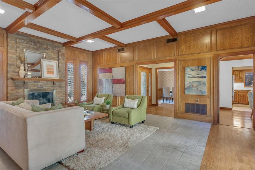 With its mid-century layout and canopy of mature trees, this home makes a striking first impression before you even step inside. The architecture hits that perfect note between classic and cool, offering a timeless look without feeling dated. The floor plan is designed for flexibility and multigenerational living, with spaces that flow easily yet offer privacy where it counts as well as a little surprise at every corner. The main living room feels both vintage and inviting, with a coffered ceiling accented by rich beams, paneled walls, and a classic brick fireplace. Tall windows with etched-glass patterns filter the light just right, and a wet bar makes entertaining easy. The dining area flows into a kitchen that blends vintage charm with modern function, featuring an island, double ovens that have stood the test of time, under-cabinet lighting, and plenty of storage. The breakfast room, with its wood-clad vaulted ceiling, is bright, warm, and easy to love. The second living area gives off unmistakable Harry Potter vibes, complete with its very own “Cupboard Under the Stairs.” Whether you’re a Potterhead or just someone who appreciates a touch of whimsy, this space is a showstopper. The primary suite sits tucked away for privacy and calm, with an updated bath, dual vanities and his and her closets. Right next door, a bonus room offers pure flexibility as an office, nursery, gym, or creative studio. And there's an oversized closet with a secret room tucked inside, perfect for storage, a cozy hideaway, or your own “Room of Requirement.” It could also be a gun safe. Hey, this is Texas. We don’t judge. Upstairs, a generous loft features built-in desks, and two oversized bedrms each have full baths. At the heart of the home lies the courtyard, surrounded by glass and natural light, and the fenced backyard offers space for a pool or garden. Every corner of 7203 Duffield tells its own story, combining character, flexibility, and just enough magic to make it unforgettable.