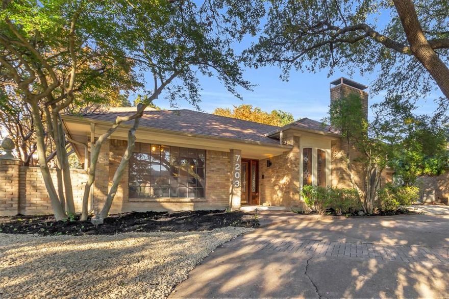 With its mid-century layout and canopy of mature trees, this home makes a striking first impression before you even step inside. The architecture hits that perfect note between classic and cool, offering a timeless look without feeling dated. The floor plan is designed for flexibility and multigenerational living, with spaces that flow easily yet offer privacy where it counts as well as a little surprise at every corner. The main living room feels both vintage and inviting, with a coffered ceiling accented by rich beams, paneled walls, and a classic brick fireplace. Tall windows with etched-glass patterns filter the light just right, and a wet bar makes entertaining easy. The dining area flows into a kitchen that blends vintage charm with modern function, featuring an island, double ovens that have stood the test of time, under-cabinet lighting, and plenty of storage. The breakfast room, with its wood-clad vaulted ceiling, is bright, warm, and easy to love. The second living area gives off unmistakable Harry Potter vibes, complete with its very own “Cupboard Under the Stairs.” Whether you’re a Potterhead or just someone who appreciates a touch of whimsy, this space is a showstopper. The primary suite sits tucked away for privacy and calm, with an updated bath, dual vanities and his and her closets. Right next door, a bonus room offers pure flexibility as an office, nursery, gym, or creative studio. And there's an oversized closet with a secret room tucked inside, perfect for storage, a cozy hideaway, or your own “Room of Requirement.” It could also be a gun safe. Hey, this is Texas. We don’t judge. Upstairs, a generous loft features built-in desks, and two oversized bedrms each have full baths. At the heart of the home lies the courtyard, surrounded by glass and natural light, and the fenced backyard offers space for a pool or garden. Every corner of 7203 Duffield tells its own story, combining character, flexibility, and just enough magic to make it unforgettable.