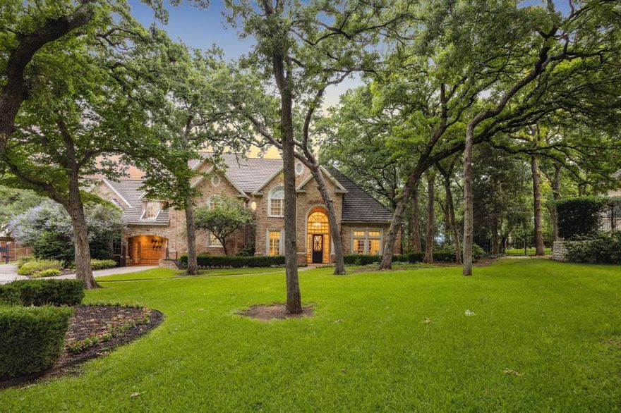 Welcome to 1260 Stanhope Court. Stunning curb appeal combining classic architecture with modern luxury, boasting stately wood and stone finishes and resort-level outdoor living, all in Southlake’s award-winning Carroll ISD. This home exudes today's most popular modern updates while retaining a warm and inviting classic ambiance. The open-concept design makes it easy to entertain or enjoy quiet family evenings. Step outside to your private oasis—a one-acre, heavily treed lot provides plenty of space and privacy. The backyard features a stunning pool and waterfall, along with a 300-square-foot custom pool casita and custom putting green. This versatile space can serve as an additional 5th bedroom or living space, tailored to your family's needs. The four-car garage and privately gated porte-cochere are a buyer's favorite, providing ample parking tucked away in one of Southlake's premier cul-de-sac streets.