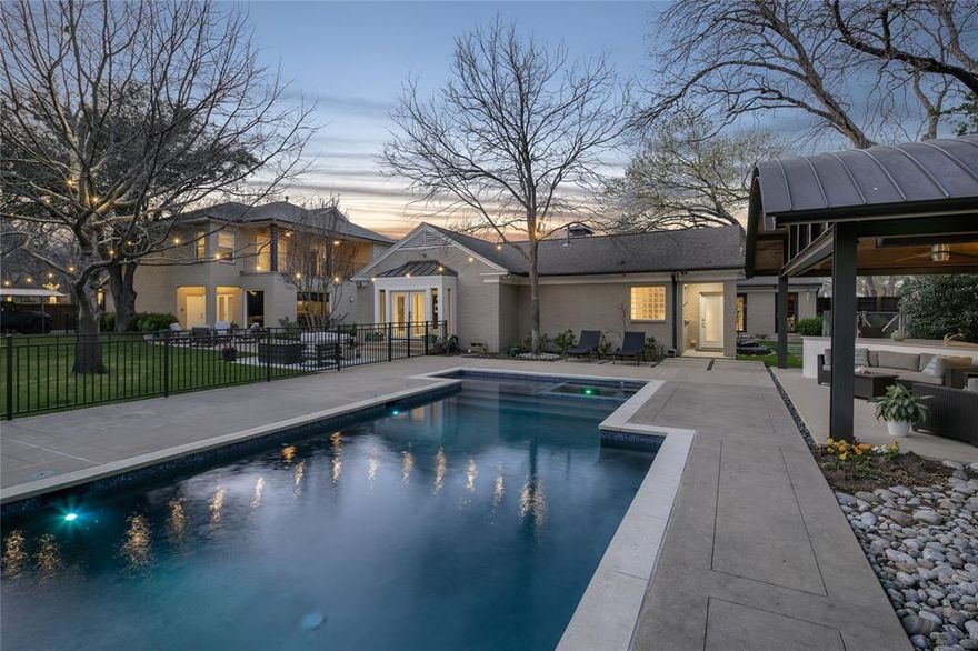 Situated on the prominent corner of Crooked and Strait Lane on a 0.78-acre lot, this 5-bedroom home with mid-century architectural elements has been extensively remodeled and expanded. A backyard oasis features a sports-field sized grassy backyard lined with mature landscaping that is anchored by a steel constructed grilling and entertaining pavilion overlooking the pool and spa. After a large circle drive and stunning curved port cochere, one is greeted by a formal living area with raised barrel-vaulted ceilings and views out to the courtyard gardens. The gourmet kitchen with lighted quartzite island opens to a breakfast room with banquette seating.  The home lives mainly on one level with two living areas, two dining areas, office (putting green outside) and four bedrooms, including the primary suite, all on the first floor. Upstairs is an exceptional media room with Control4 theater and 4K projector, a huge gameroom and a guest suite with a covered terrace overlooking the grounds.