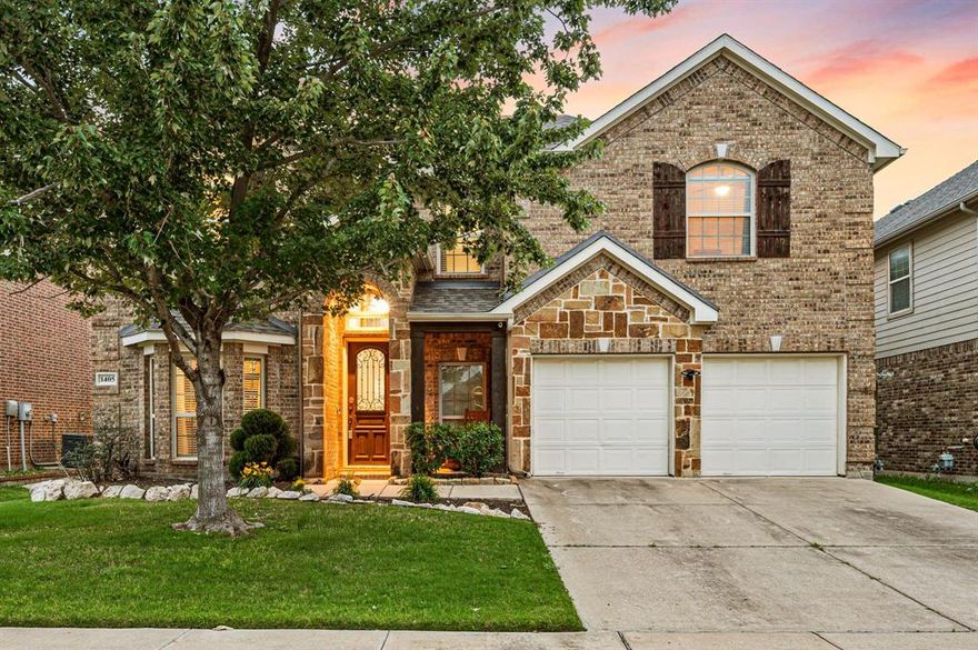 Welcome to this beautifully upgraded 5-bedroom, 3.5-bath home in highly sought-after Northwest ISD, this thoughtfully designed living space perfectly blends comfort, style, and modern convenience. From the moment you enter, you’re greeted by upgraded hardwood flooring flowing through the entry, designated office, living, and dining areas, complemented by custom paint that adds warmth and character throughout. The open-concept layout seamlessly connects the spacious living room, anchored by a stunning stone fireplace, to the chef’s kitchen featuring a large island, ample cabinetry, and upgraded appliances including a KitchenAid dishwasher, Samsung refrigerator, and Samsung microwave. Updated lighting fixtures in both the dining room and kitchen eating area add a fresh, modern touch. The primary suite is conveniently located downstairs, offering a private retreat with upgraded carpet and generous space. Upstairs, you’ll find four additional bedrooms along with a versatile flex space, perfect for a game room, second living area, or additional office to fit your lifestyle. Step outside to your private backyard oasis featuring an expanded custom flagstone patio, professionally enhanced landscaping with added trees, and an upgraded 12-zone sprinkler system, ideal for relaxing or entertaining. This home also stands out with its fully integrated Vivint Smart Home & Security System (paid off and conveying), including smart thermostat, door locks, dimmable lighting, doorbell camera, and glass break detectors for added peace of mind. Additional highlights include upgraded carpet in key areas, a custom epoxy-finished garage floor, and a roof replaced approximately five years ago. With its flexible layout, extensive upgrades, smart home features, and prime location, this home truly checks all the boxes, don’t miss your opportunity to make it yours!
