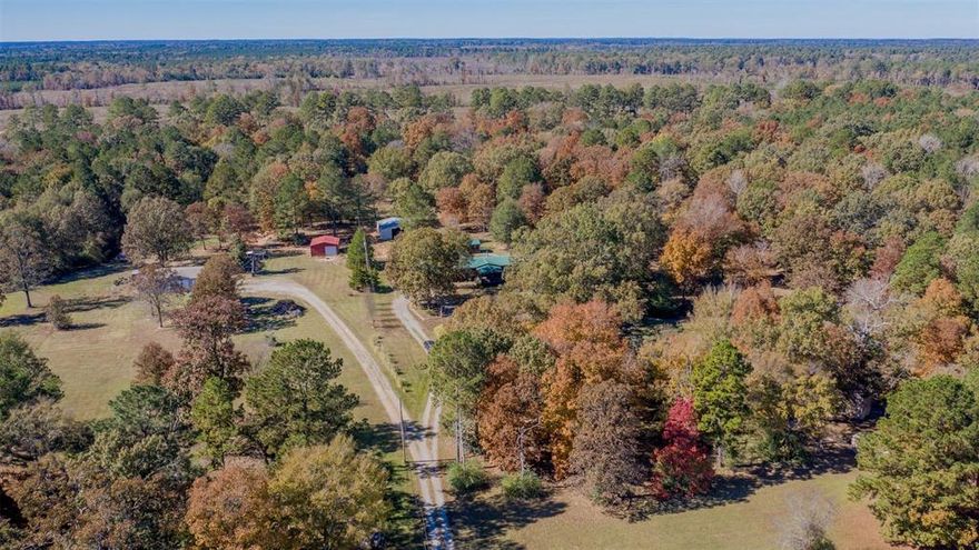 Discover peaceful country living on 10 acres with this spacious 3-bedroom, 2-bathroom home. Property includes a large living area with a stone fireplace, an open kitchen layout with ample cabinet and counter space, an island, and a generous dining area. The primary suite includes a walk in closet and full bath with great storage space. Outside, enjoy multiple porches, a long private driveway, and several buildings suitable for storage, equipment, or workshop use. Property also includes RV and Boat storage that is perfect for outdoor enthusiasts! The land offers a mix of open space and mature trees, providing room for livestock, gardening, or recreational use. A separate cabin-style structure adds additional flexibility for air conditioned storage or hobby space. If you are looking for acreage, privacy, and space, this property provides endless possibilities! Schedule your showing today.