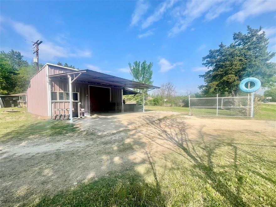 Entrepreneurs Dream.  Live on the same land as your business with both a 1672 square foot home and a 720 square foot metal shop building that are spaced apart from each other.  The Commercial building is 700' enclosed and a total of 3040 feet under cover with the attached 1168' canopy and 1152' carport sections.  There is an added convenience of Two Electric Meters on the property that allows for the home and the commercial building to have their own bill.   This property boasts of great visibility as it is sitting at two highly traveled roads and near two convenient stores with fueling stations.