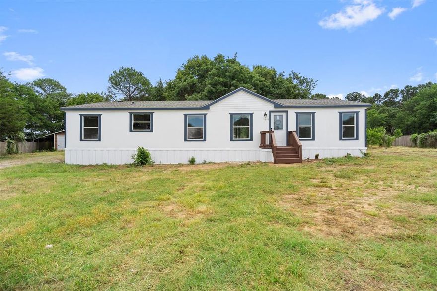 Welcome to a charming home nestled in the peaceful Meadow Lands community of Johnson County. This inviting doublewide property offers spacious living on just over an acre of land, providing plenty of room to stretch out and enjoy country living. Inside, you'll find a warm and welcoming layout featuring a cozy wood-burning fireplace, an open living and dining area, and a well-equipped kitchen with electric appliances. The primary suite offers a private retreat, while two additional bedrooms provide flexible space for family, guests, or a home office. The home also includes a utility room and a carport with covered parking. With no homeowners association, you’ll enjoy the freedom to make this property truly your own. Located in the Joshua school district, this property combines comfort, space, and value in a serene setting.