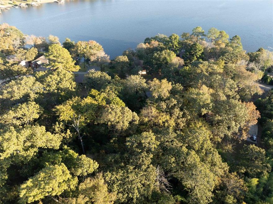 Heavily wooded lot in a gated community located across the street from the lake with a great view of the 365 acre spring fed Callender Lake.  This lot will be an excellent location to build your lake home or full time residence.  Lot is about .21 acres and is about 65 feet wide and 156 feet depth.  Homes in this community must be site built and be at least 960 sq. feet or larger.  No mobile homes  are allowed.  RV's can be brought in and out and stayed in two weeks each month, but can not be lived in full time.  Electricity and Water are at the street and a septic will be required when you build your home.  This community has a boat ramp, fishing pier, children's playground, park areas for your use, lake swim area, resale shop, great fishing and boating, and so much more for your enjoyment.   Come see this great lot today and start living the LAKE LIFE!!!