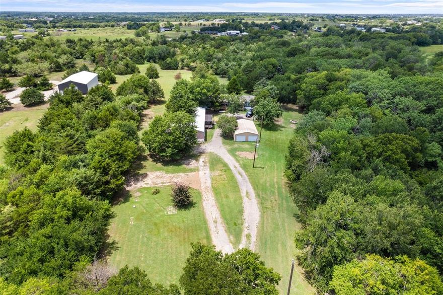 Welcome to 9048 County Road 2472, a serene 10-acre retreat nestled in the tranquil countryside of Royse City, Texas. This unique property offers a harmonious blend of rural charm and modern convenience, featuring two well-maintained mobile homes, each with separate utility hookups and septic systems. The main residence is a 2023 model that boasts a spacious 5-bedroom, 3-bathroom layout designed for comfortable family living. Its open-concept design seamlessly connects the living room, dining area, and kitchen, which is equipped with a central island ideal for meal preparation and gatherings. Additional amenities include a dedicated utility room for laundry and a recently added front porch with a cover, providing a perfect spot to enjoy the peaceful surroundings. The secondary residence (1998 model) is 3 bed, 2 bath, and is approx. 1152 sq ft. This home presents an excellent opportunity for rental income or guest accommodations. Its separate utilities and septic system ensure privacy and independence from the main residence. Property highlights include: Expansive 10-acre lot with mature trees and a seasonal creek, attracting local wildlife such as deer and rabbits, a storage building on-site offers additional space for equipment or personal belongings, and farm equipment currently on the property is negotiable, providing potential value for agricultural pursuits. Situated in Hunt County, this property offers the tranquility of country living while being just a short drive from the amenities of Royse City. The city is known for its small-town charm, vibrant community events, and a growing economy. Residents enjoy access to local shops, restaurants, and parks, as well as proximity to larger urban centers like Dallas. Experience the perfect balance of peaceful rural life and convenient access to city amenities at 9048 County Road 2472. Whether you’re seeking a family homestead, an investment opportunity, or a private retreat, this property offers endless possibilities.