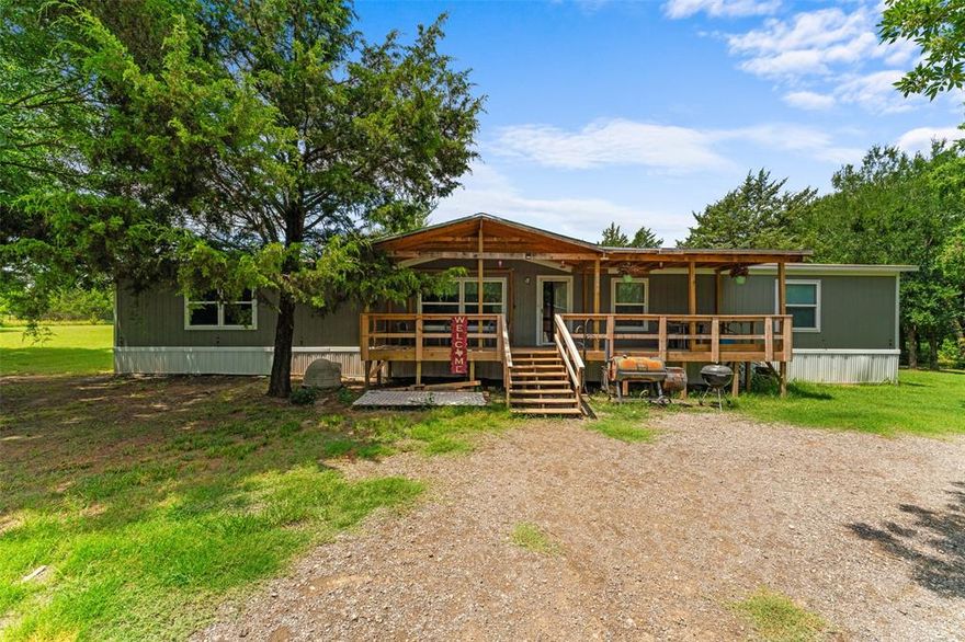 Welcome to 9048 County Road 2472, a serene 10-acre retreat nestled in the tranquil countryside of Royse City, Texas. This unique property offers a harmonious blend of rural charm and modern convenience, featuring two well-maintained mobile homes, each with separate utility hookups and septic systems. The main residence is a 2023 model that boasts a spacious 5-bedroom, 3-bathroom layout designed for comfortable family living. Its open-concept design seamlessly connects the living room, dining area, and kitchen, which is equipped with a central island ideal for meal preparation and gatherings. Additional amenities include a dedicated utility room for laundry and a recently added front porch with a cover, providing a perfect spot to enjoy the peaceful surroundings. The secondary residence (1998 model) is 3 bed, 2 bath, and is approx. 1152 sq ft. This home presents an excellent opportunity for rental income or guest accommodations. Its separate utilities and septic system ensure privacy and independence from the main residence. Property highlights include: Expansive 10-acre lot with mature trees and a seasonal creek, attracting local wildlife such as deer and rabbits, a storage building on-site offers additional space for equipment or personal belongings, and farm equipment currently on the property is negotiable, providing potential value for agricultural pursuits. Situated in Hunt County, this property offers the tranquility of country living while being just a short drive from the amenities of Royse City. The city is known for its small-town charm, vibrant community events, and a growing economy. Residents enjoy access to local shops, restaurants, and parks, as well as proximity to larger urban centers like Dallas. Experience the perfect balance of peaceful rural life and convenient access to city amenities at 9048 County Road 2472. Whether you’re seeking a family homestead, an investment opportunity, or a private retreat, this property offers endless possibilities.