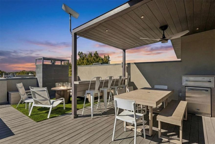 Fire pit. Rooftop bar with built-in fridge. Skyline views. This Oak Lawn modern doesn't just have outdoor space - it has two showstoppers: a private rooftop deck built for real entertaining, and a quiet walled courtyard below for morning coffee or letting a pup roam.

Inside, clean lines and natural light define every level. The main living space opens up with floor-to-ceiling windows, a striking stone fireplace, custom built-ins, and a dining area sized for hosting. The kitchen pairs sleek cabinetry with a wide island, stainless appliances, and warm light streaming in. A 2023-upgraded Savant system runs throughout — in-ceiling speakers on every level including the rooftop, smart wiring, and phone-controlled audio and video that can play different sources in different rooms.

The primary suite offers a fireplace, abundant built-in storage, and a spa-caliber bath: freestanding soaking tub, oversized shower, double vanities, and warm wood detailing. Two guest bedrooms each have ensuite baths. The first-floor bedroom opens directly to the garden with built-in shelving - ready-made for a home office. Private front-entry 2-car garage.