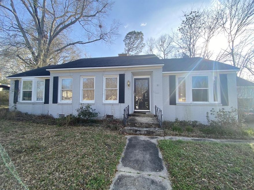 Step into timeless charm with this 1930s American classic — a one-story treasure that may just be the most precious home on the entire cul-de-sac. Nestled on a peaceful street in Marshall where you can safely stroll to the hospitals, downtown, or anywhere your day takes you, this home blends storybook character with thoughtful design. Inside, you’ll find two spacious bedrooms and two baths, each room seamlessly connected by charming interior doors that lead you gracefully from space to space — a nod to an era when homes were designed for warmth, flow, and connection. Original character shines through every corner. The main living room welcomes you with a cozy fireplace that anchors the space, perfect for gathering on cool evenings. Just beyond, a second living area or den offers its own fireplace — an inviting retreat for quiet mornings, movie nights, or curling up with a good book. The kitchen sits at the heart of the home, easily accessible from every direction, making entertaining feel natural and effortless. Upstairs above the garage, a private bedroom and full bath create the perfect guest suite, office, or bonus retreat — tucked away yet still part of the home’s inviting charm. Out back, the backyard offers space to breathe, garden, entertain, or simply enjoy peaceful evenings under the East Texas sky. This isn’t just a house —it’s the kind of home people slow down to admire. The kind with stories in its walls, warmth in its fireplaces, and the kind of charm that’s nearly impossible to replicate. On a quiet cul-de-sac in the heart of Marshall, it may very well be the sweetest home on the street.
