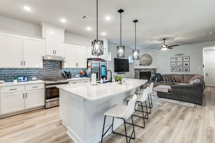 Welcome to 9349 Loggerhead Way in the highly desirable Lakes of River Trails community. This spacious 3-bedroom, 2.5-bath residence includes a study enclosed with French doors & custom cabinets, offering the perfect flex space for a home office or guest room. The open-concept floor plan blends functionality with elevated design, featuring luxury plank flooring, 8’ interior doors, and upgraded lighting throughout.The gourmet kitchen is a chef’s dream, complete with sleek quartz countertops, custom Pure White shaker cabinets, a Blanco Silgranit undermount sink in metallic gray, stainless steel GE appliances, pendant lighting, and an oversized island—ideal for both meal prep and casual gatherings. The living room features a striking fireplace with Emser polished tile surround and a painted floating box mantel that extends wall-to-wall for a designer finish. Retreat to the spacious owner’s suite, where you’ll find a spa-like bathroom featuring a drop-in soaking tub, separate rain shower with polished tile and pebble mosaic floor, dual vanities, and Moen brushed nickel fixtures. Secondary bedrooms are located upstairs, along with plush carpeting and ample storage space. Additional highlights include a turf-covered back yard, Custom shelves and cabinetry in study, covered patio, cedar garage door, energy-efficient systems, security system prewire, and a beautifully coordinated exterior with Casa Blanca brick and Country French stone. Located within top-rated HEB ISD and just minutes from trails, parks, shopping, and DFW Airport. Smart refrigerator and Samsung W+D convey with property.