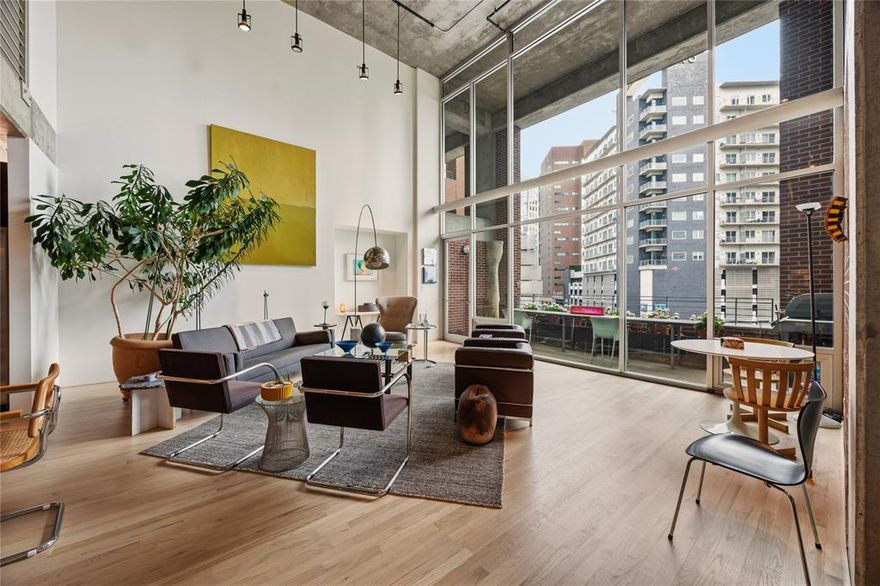 Experience true urban loft living in the heart of Uptown. Located in 2011 Cedar Springs, a boutique red-brick mid-rise, this striking contemporary residence offers 2,306 square feet of open living space highlighted by dramatic two-story windows that flood the home with natural light and showcase dynamic city views. The main level features natural white oak floors and an expansive living and dining area designed for both everyday comfort and entertaining. The modern kitchen with center island provides ample space for casual dining and meal prep. Just off the entry, a cozy library lounge (a potential second bedroom!) and full bath offers the perfect spot for reading, watching TV, or hosting overnight guests. Upstairs, the open loft-style offer overlooks the living space below. The sizable primary suite boasts a full wall of windows and includes a spacious bath and large closet. Laundry and additional storage round out the upstairs. Building amenities include a resort-style pool and outdoor lounging area with an outdoor kitchen, covered parking and a dog park. Enjoy an unbeatable, walkable location near some of Dallas’ most popular destinations, including American Airlines Center, Klyde Warren Park, the Katy Trail, and the Dallas Arts District. Plus you can enjoy the restaurants, nightlife, and entertainment of Victory Park and Uptown just steps away. Loft 305 combines architectural character, generous space, and an exceptional location for a sophisticated Uptown lifestyle.