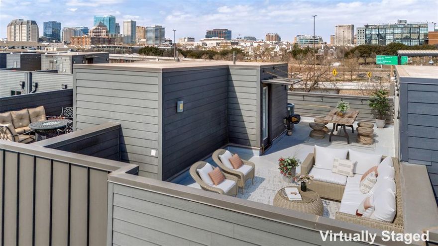 Modern 3-story townhome crowned with a rooftop terrace showcasing stunning views of downtown Dallas. Designed for flexible living, the first floor features a private bedroom with en-suite bath and a custom Murphy bed—ideal as a guest suite or home office—along with convenient under-stair storage for added functionality and garage access. The second level offers an open-concept living and dining area filled with natural light, alongside a well-appointed kitchen featuring quartz countertops, a designer backsplash, custom cabinetry, stainless steel appliances, and a gas cooktop. The kitchen also includes a spacious walk-in pantry with pocket doors and the refrigerator conveys with the home. Just off the kitchen is a dry bar with additional cabinetry and a built-in beverage refrigerator, perfect for entertaining.  A convenient half bath completes this level. The third floor hosts the primary bedroom with an en-suite bathroom featuring dual sinks, a spacious shower, and a generous walk-in closet. An additional secondary bedroom with built-in storage is also located on this level, along with a dedicated laundry closet. The fourth-level rooftop terrace is a true highlight—wired for a hot tub and offering sweeping views of downtown Dallas. Thoughtful storage is found throughout the home, and wood and tile flooring run throughout—no carpet.  An alley entrance leads to a private 2-car garage, while a small, turfed and gated front space offers a charming, low-maintenance outdoor area perfect for pets or enjoying a morning coffee. Ideally located near major highways, dining, and entertainment, this townhome offers stylish urban living with exceptional convenience.