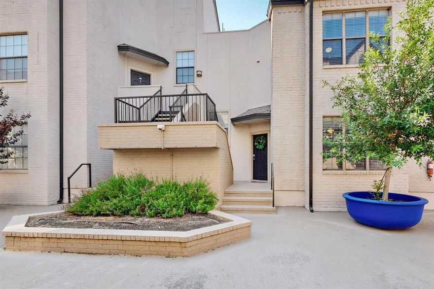 Welcome the Parks on Travis Condos, a gated community in a highly walkable Uptown Dallas location—walk to Knox-Henderson, Katy Trail, West Village, Turtle Creek & multiple neighborhood parks! This two-story unit has been thoroughly cared for, boasting recent updates throughout: FRESH PAINT, BOTH BATHROOMS REMODELED + ALL MAJOR SYSTEMS SERVICED. Versatile first-floor layout includes the main living room, galley-style kitchen, refreshed powder room & formal dining or second living area featuring a wood-burning fireplace. Skylights & vaulted ceilings make for great natural light throughout. Kitchen is complete with granite countertops, ample cabinet storage, SS appliances & reverse osmosis water filtration system—plus easy access to the unit’s private patio right off the kitchen—great for indoor-outdoor entertaining! All downstairs flooring redone in 2015. NEW carpet on staircase + second floor (2025). Primary suite upstairs boasts more high ceilings, room for seating & a spacious ensuite fully remodeled with all new fixtures, accent tiling & walk-in glass shower. Second bedroom or office space adjacent to the primary. Use as a guest room, study, or workout room! Laundry conveniently located upstairs next to walk-in closet space. Community amenities include a sparkling pool, gated & secured entrances, parking garage & low HOA fees. Private storage unit + two parking spaces included. All in an UNBEATABLE LOCATION in the heart of Dallas, steps to parks, schools, shopping, dining & entertainment for all ages!