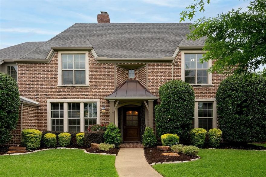 Grounded by timeless design and modern comfort, 6015 Orchid Lane is an ode to classic Dallas architecture. This stately Preston Hollow residence welcomes you with impeccable curb appeal—brick exterior, manicured landscaping, and a charming front walkway that leads to a home where sophistication meets everyday ease. Gleaming hardwood floors and classic shutters set an elegant tone, while the open, light-filled floor plan invites both grand entertaining and intimate family moments. The heart of the home is a spacious kitchen that flows effortlessly into the family and dining rooms, making gatherings of all sizes feel elevated & inviting. A cozy stone fireplace and designer touches throughout heighten the home’s classic appeal. The first-floor primary suite sets the stage for quiet moments with tranquil backyard views, a luxurious, renovated bath, and an expansive walk-in closet. With five bedrooms, five full baths, and a powder room, there’s space for everyone—whether enjoying solitude in the downstairs den, hosting game night in the upstairs game room, or relaxing in the expansive, turfed backyard. Step outdoors and you’ll find a covered patio and ample green space that promises memorable al fresco evenings, while a three-car garage and generous additional parking complete this .43 acre property. Positioned across from the prestigious St. Mark’s School and moments from Dallas’ finest shops, dining, and amenities, 6015 Orchid Lane is more than a home—it’s an invitation to create a lifetime of memories.