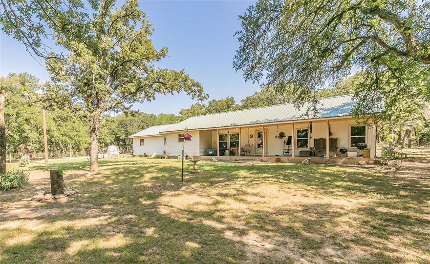 INCREDIBLE PRICE IMPROVEMENT, MOTIVATED SELLERS at this gorgeous 7.44 acre farm with endless possibilities for suitability considering the hay pasture positioned before the 3 bedroom, 2 bath, 2 car garage ranch style home, covered RV and boat parking with 220 power and 50 amp breaker, and a variety of multi-purpose out buildings.  Follow the long gravel driveway to the well kept, modest home boasting many desirable features such as a metal roof, an open floor plan, separate primary bedroom and ensuite, generously sized secondary bedrooms, a large laundry room, lots of storage, and updated flooring. Enjoy private tranquility from the substantial covered front porch or the patio out back.  The immediate front and back yards have been cross fenced for pets and there is a temporary fence out front for a garden area.  Take a dip in the 12'x25' above ground pool with a gas powered heater for early and late season swimming after a quick change in the pool shed appointed with electricity. There are out buildings well suited for the private well, pool accessories, extra storage, hobbies, chickens, gardening, et cetera.  The acreage is also well kept, ready for your animals and your big dreams.  Wear your boots and come walk the fenced property lines and see the many reasons why you should call this place home.  We encourage you to sit, listen, and enjoy the view from the front porch.  This place is truly special; don't miss your opportunity to own a piece of Texas country!