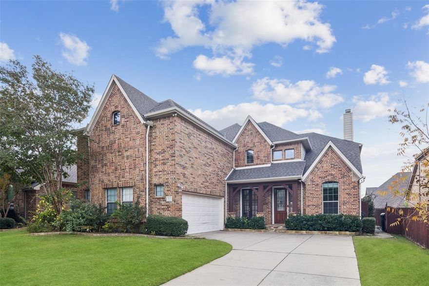 This stunning home shows like a model and is located in the quiet, established, and highly sought-after CrownRidge neighborhood of Frisco. Charming curb appeal welcomes you with a quaint front porch and elegant leaded-glass wood door. Two separate entrances with a rare double-door main entry. Inside, rich wood floors, high ceilings, and walls of windows create a warm, inviting atmosphere filled with natural light. The kitchen is a chef’s dream, featuring granite counters, abundant cabinetry, generous prep space, a butler’s pantry, and a bright breakfast room. The open-concept layout flows effortlessly and includes the desirable primary suite on the main level along with a secondary bedroom—perfect as a bedroom or office. Upstairs, enjoy a spacious game room, dedicated media room, and three additional bedrooms with ceiling fans plus two full baths. Fully paid off solar system (11kW capacity). No carpet, for easy maintenance, hardwood floors throughout. Smart-automation switches. North facing entrance. The relaxing backyard offers an oversized flagstone patio with a large arbor and ceiling fan—ideal for outdoor living and entertaining. Schedule a private showing today and experience elevated living in a prime Frisco location!  Mortgage savings may be available for buyers of this listing.
