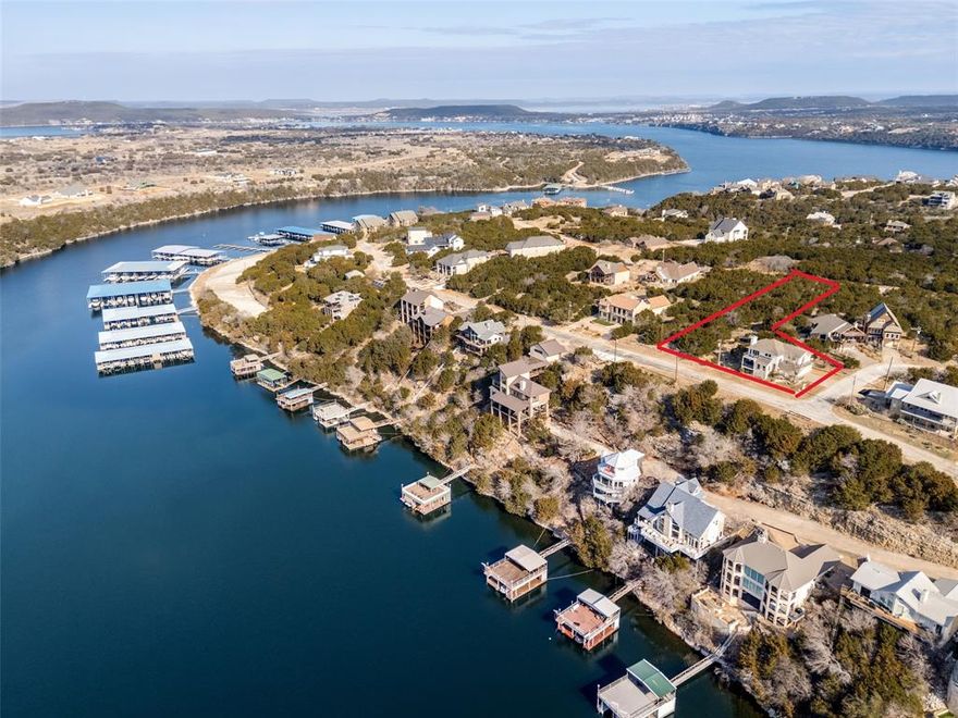 Exceptional two lot estate property with transferable boat slip, a truly rare find. Experience refined lake-country living in this exquisitely updated residence located within the prestigious, gated Cliffs Resort on Possum Kingdom Lake. Offering stunning lake views and an exceptional blend of luxury, comfort, and resort-style amenities, this furnished home is a rare turnkey opportunity. The thoughtfully designed floor plan features three bedrooms, two and a half bathrooms, and two spacious living areas, ideal for both everyday living and elevated entertaining. A large eat-in kitchen anchors the home, offering ample countertop space and an inviting layout perfect for gatherings, while expansive windows capture breathtaking lake vistas throughout the living spaces. Recent enhancements include fresh exterior and interior paint, rich hardwood flooring creating a seamless, upscale aesthetic throughout. The primary suite is a true retreat, highlighted by a completely remodeled, spa-inspired primary bathroom designed for relaxation and sophistication. Elegant statement chandeliers elevate both the front entry and dining room, adding architectural interest and a strong sense of arrival. Outdoor living is equally impressive. Fresh landscaping surrounds the home with curated bushes, exotic plants, and stone accents. A rare second lot expands the lifestyle possibilities, featuring a private spa-hot tub and a thoughtfully designed fire pit area with additional landscaping—perfect for entertaining or enjoying tranquil evenings under the Texas sky. The home is being offered fully furnished, allowing for an effortless transition and immediate enjoyment. For those seeking future expansion, the property includes two complete sets of architectural plans for a potential home addition, complete with multiple renderings showcasing pool and backyard concepts—an exceptional opportunity to further customize an already impressive residence.