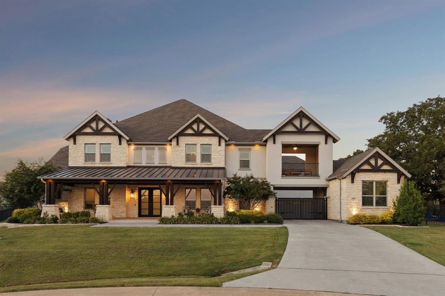 Welcome to a true destination multigenerational home in the desirable Townlake community in Flower Mound, situated on a premium lake-facing lot at a quiet cul-de-sac. Set on 0.8 acres, this property offers generous outdoor space for activities, pets, and entertaining. An inviting front porch leads to a grand foyer with dual staircases and a private office with french doors. The open floor plan blends traditional and contemporary elements, offering abundant natural light, clean lines, and sliding glass door for seamless indoor-outdoor living. The kitchen features an oversized island, premium built-in appliances, and a butler’s pantry. The spacious primary suite is a private retreat with spa-inspired bath, stand-alone soaking tub, walk-in shower, and his-and-hers closets.The private first-floor apartment features its own entrance, living area, and kitchenette—creating an ideal retreat for extended family, long-term guests, or live-in support while maintaining complete privacy from the main home. Upstairs offers three ensuite bedrooms with walk-in closets, a game room, stadium sitting media room, conditioned storage room, and a covered balcony overlooking the lake. The backyard is a resort-style escape with a custom Robertson’s salt water pool, infinity edge spa, water features, slide, covered patio with fireplace, pergola, and centennial native oaks. A porte-cochère leads to a private motor court and four-car garage. New roof. Conveniently located near award-winning schools and DFW Airport.