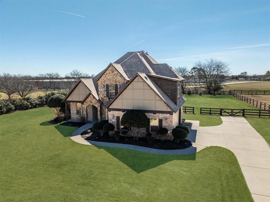 There’s a reason so many buyers are drawn to Hills of Argyle - it’s the kind of neighborhood people dream of calling home. With 1+ acre homesites, a peaceful setting, and a true sense of community, it offers a small-town feel where neighbors connect, kids play outside, and evening walks along the trails become part of your routine. Situated on a 1-acre lot, this custom home offers the space, privacy, and flexibility that make acreage living in Argyle so desirable. The expansive front lawn, deep setback, and split-rail fencing create a welcoming arrival, while the backyard provides endless potential for a future pool, outdoor living, or simply enjoying the open space. Inside, the home blends warmth and character with vaulted ceilings, hand-scraped hardwood floors, and updated designer lighting. The living room is anchored by a floor-to-ceiling stone fireplace and framed by oversized windows that capture backyard views. The kitchen features granite countertops, custom wood cabinetry, breakfast bar seating, and a walk-in pantry, with both a breakfast nook and formal dining area for everyday living or entertaining. A private front office offers dedicated work-from-home space. The primary suite overlooks the backyard and includes hardwood flooring, dual granite vanities, a soaking tub, separate shower, and walk-in closet. Upstairs you’ll find three bedrooms plus a versatile bonus room perfect for a game room, media room, or kids’ retreat. Located in Argyle ISD and zoned to Hilltop Elementary, with convenient access to Hwy 377 and I-35W, this property offers the rare combination of space, community, and accessibility that defines life in Argyle.