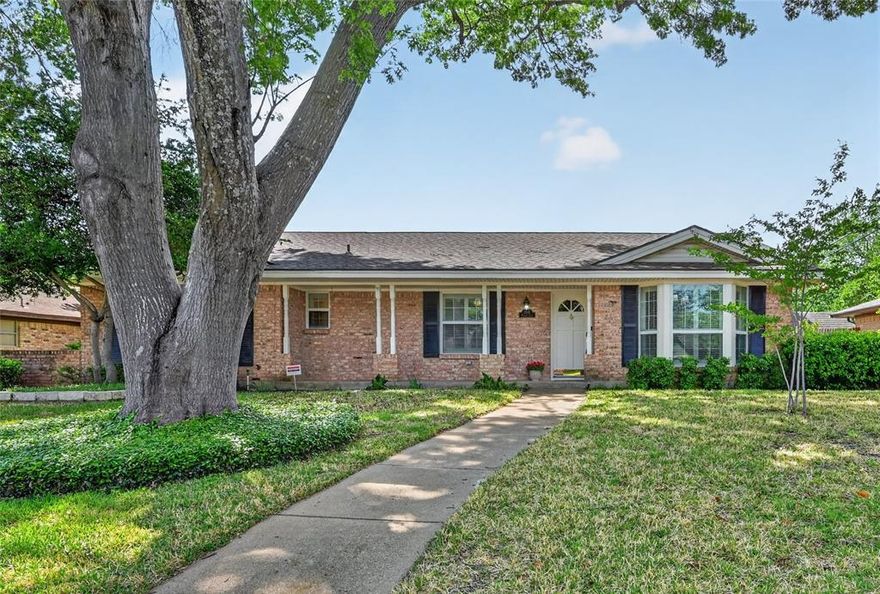 Step into this beautifully maintained 1970s gem, nestled in the heart of the highly sought-after Meadow Oaks subdivision in North Grand Prairie. This established, tree-lined neighborhood offers a serene atmosphere. The spacious front porch is the perfect welcome. The second you step inside, you'll feel like you're home. Spanning 2,131 square feet, this home features three spacious bedrooms, two and a half bathrooms, a utility room, and versatile parking options including a rear entry two-car garage plus an additional carport. The heart of the home is the expansive living area, anchored by a classic floor-to-ceiling brick fireplace with an oversized hearth. Custom built-ins flank the fireplace and provide elegant storage and display space, adding a touch of timeless sophistication. The kitchen features a gas cook top, sleek granite countertops, a timeless brick backsplash, a built-in oven featuring a dedicated warming drawer, and a cozy eat-in nook. A standout feature of this home is the tastefully designed sunroom. With soaring wood paneled ceilings and large windows, it serves as a bright, peaceful sanctuary and the perfect flex-space to suit your needs. The room off the entry has so many possibilities! You could make it a beautiful oversized dining room, an additional living and dining space or even make it into a home office. There are so many possibilities with this home. The spacious backyard with a covered patio is ideal for entertaining. The lot is graced with trees which help provide shade from the Texas heat. Don't miss the chance to own a piece of North Grand Prairie’s finest established living. Schedule your showing today!