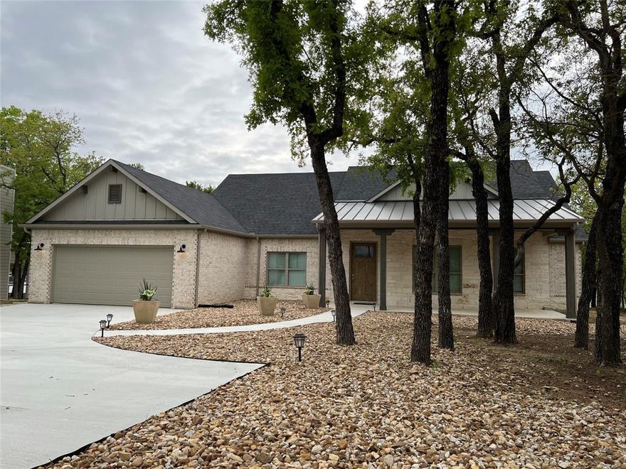 Welcome to your dream lake retreat in the highly sought-after Three Fingers Coves community on the north end of Lake Bridgeport. This beautifully maintained, like-new home offers the perfect balance of comfort, functionality, and scenic tranquility.

Enjoy peaceful waterfront views from the expansive, covered back porch, overlooking a mature tree-lined, half-acre lot with 136 feet of private shoreline. Whether you're relaxing or entertaining, this outdoor space sets the tone for lakeside living. The property includes a newly built dock with a covered single boat slip and a 6,000 lb lift—ready for all your lake adventures.

Step inside to an open-concept layout designed for effortless living and entertaining. The spacious kitchen, dining, and living areas flow seamlessly together, while four comfortable bedrooms offer plenty of space for family and guests.

Built by Hedgefield Homes of Fort Worth, the home was constructed with exceptional quality and fully documented attention to detail.

Additional features include: House is built fully out of the FEMA 100-year flood zone elevation, no flood insurance required. Large, paved driveway leading to a 2-car, insulated garage. A 3,000-gallon water storage tank and advanced filtration system, with the flexibility to either use bulk freshwater delivery or draw and treat water directly from the lake. A separate irrigation system that sources water from the lake for yard maintenance. Option to purchase the home mostly furnished for a turnkey experience. Meticulously maintained by the original owner.

This is a rare opportunity to own a pristine lakefront home in a quiet, established neighborhood. Showings and introductory calls are available at your convenience—just reach out to schedule a visit