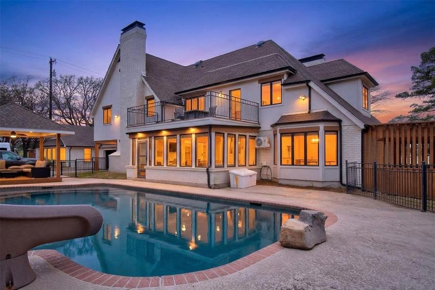 Experience waterside living in the heart of Highland Village on this rare 4+ acre private retreat overlooking the water and scenic views of Doubletree Ranch Park. Tucked away at the end of a long, inviting driveway, this impressive estate offers space, privacy, and exceptional amenities in a truly one-of-a-kind setting. Step inside the main home and be welcomed by a dramatic open stairwell with cathedral ceilings, rich wood floors, classic white paneling, and a stunning chandelier that creates an elegant first impression. The main level offers a versatile layout with two spacious living areas, a secondary bedroom, private study, formal dining room, and the heart of the home, the kitchen and family living space. The living room features decorative wood beams, adding warmth and character, while the kitchen is beautifully appointed with abundant white cabinetry, accent granite countertops, double ovens, and stainless appliances. Just beyond, a bright sunroom frames picturesque views of the backyard and pool, seamlessly connecting indoor and outdoor living. Upstairs, the primary suite is a true retreat, featuring an oversized bedroom with a private sitting area, a remodeled spa-like bathroom with a large walk-in shower, and a private balcony overlooking the water, the perfect place to start or end your day. The upper level also includes three additional secondary bedrooms, providing ample space for family and guests. Step outside to enjoy the resort-style backyard, complete with a large pool, expansive deck, and sweeping water views, all backing to the natural beauty of Doubletree Ranch Park. A separate guest house offers incredible flexibility with a bedroom, living and kitchen combo, and full bathroom, making it perfect for guests, multigenerational living, or private retreat. The property’s value is uniquely enhanced by two newly surveyed additional lots, offering a rare opportunity for further development or the creation of a multi-generational family compound.